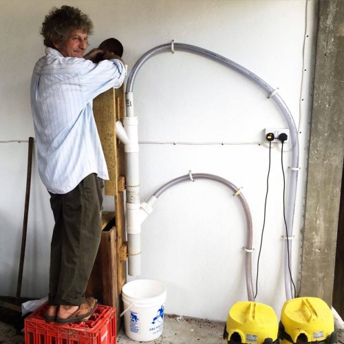 Kim with his homemade winnowing machine